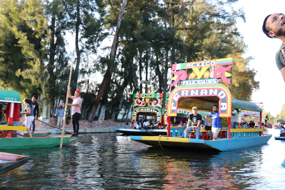 Photos of colorful boats on the water at Xochimlico